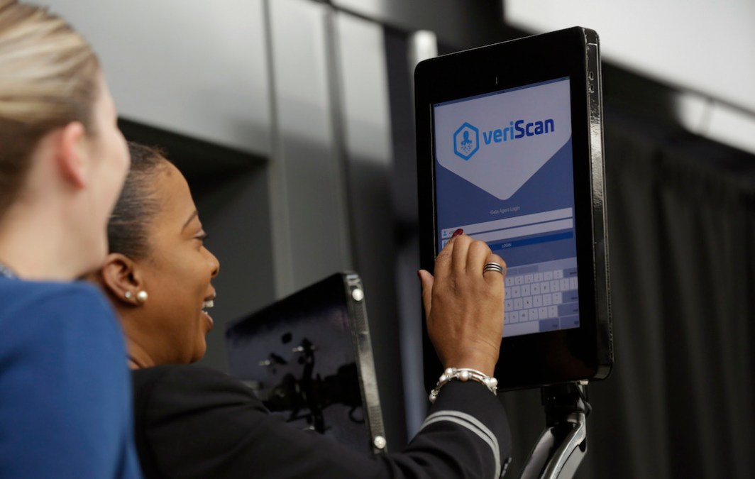 A gate attendant at Washington Dulles International Airport uses the new VeriScan facial recognition scanning system. (U.S. Customs and Border Patrol)