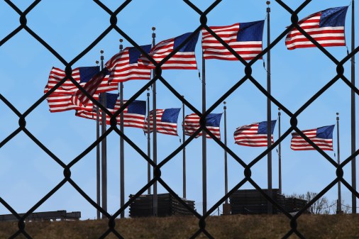 american flags and fence