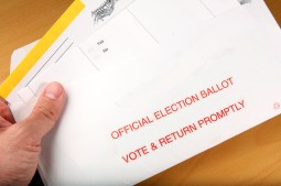 Man opening mail-in ballot