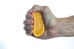 man squeezing orange