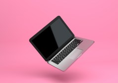 laptop floating on pink background