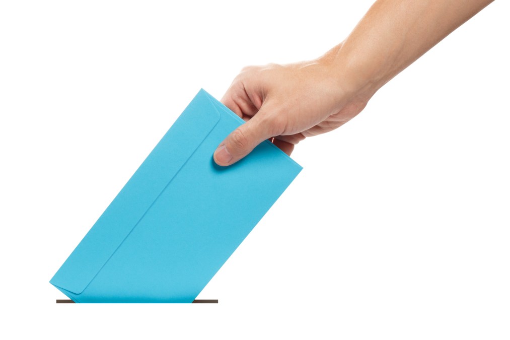 Hand sending a blue envelope