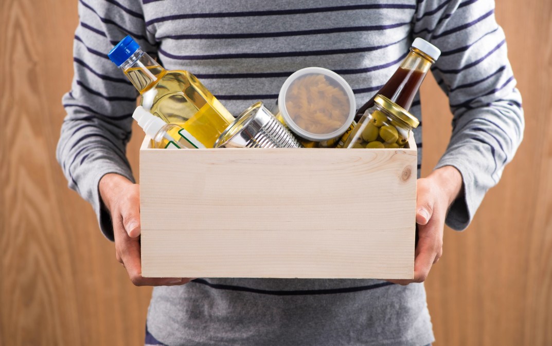 man holding box with food