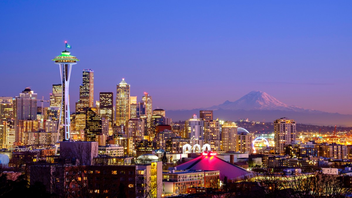Seattle skyline at night with Mt Rainier in the distance
