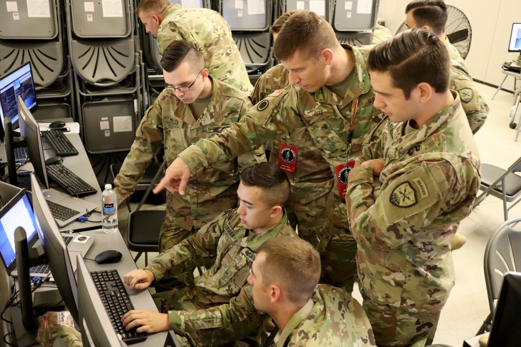 military guys around computer