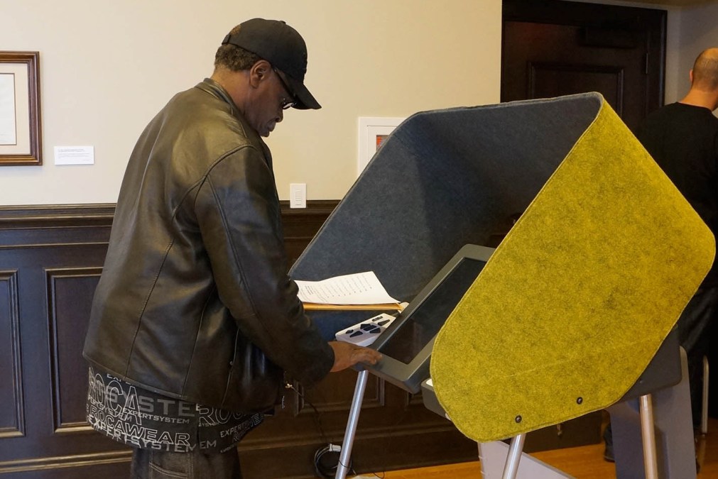 Man using a voting machine