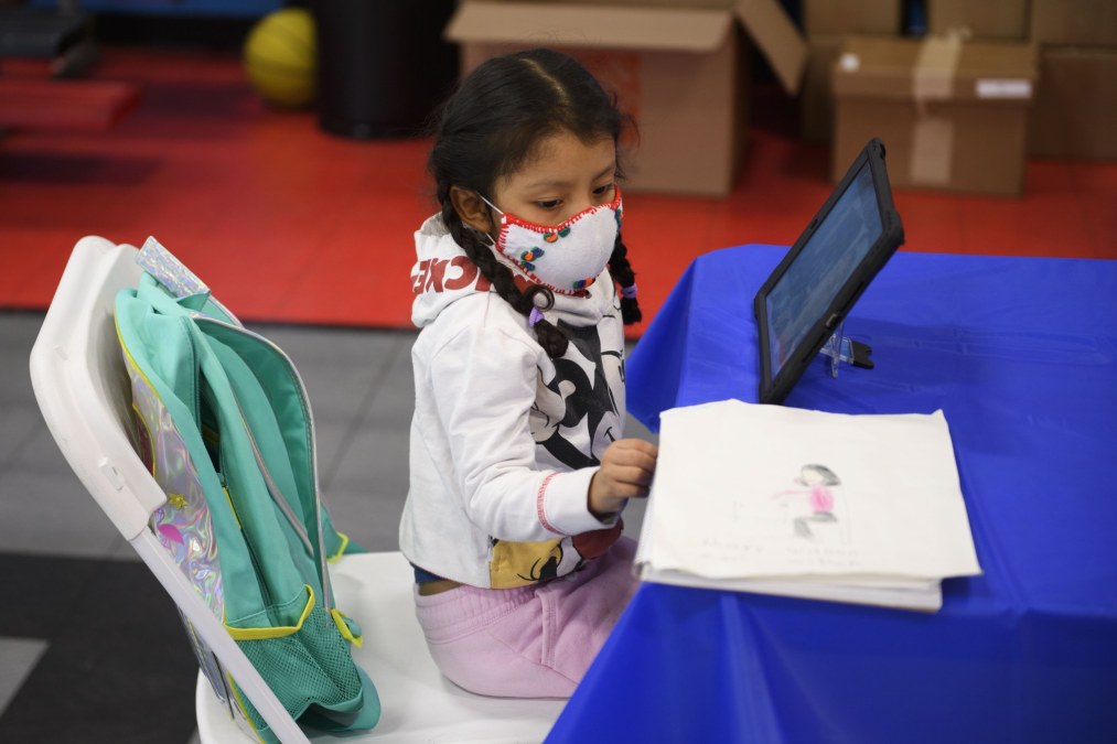 child studying on tablet