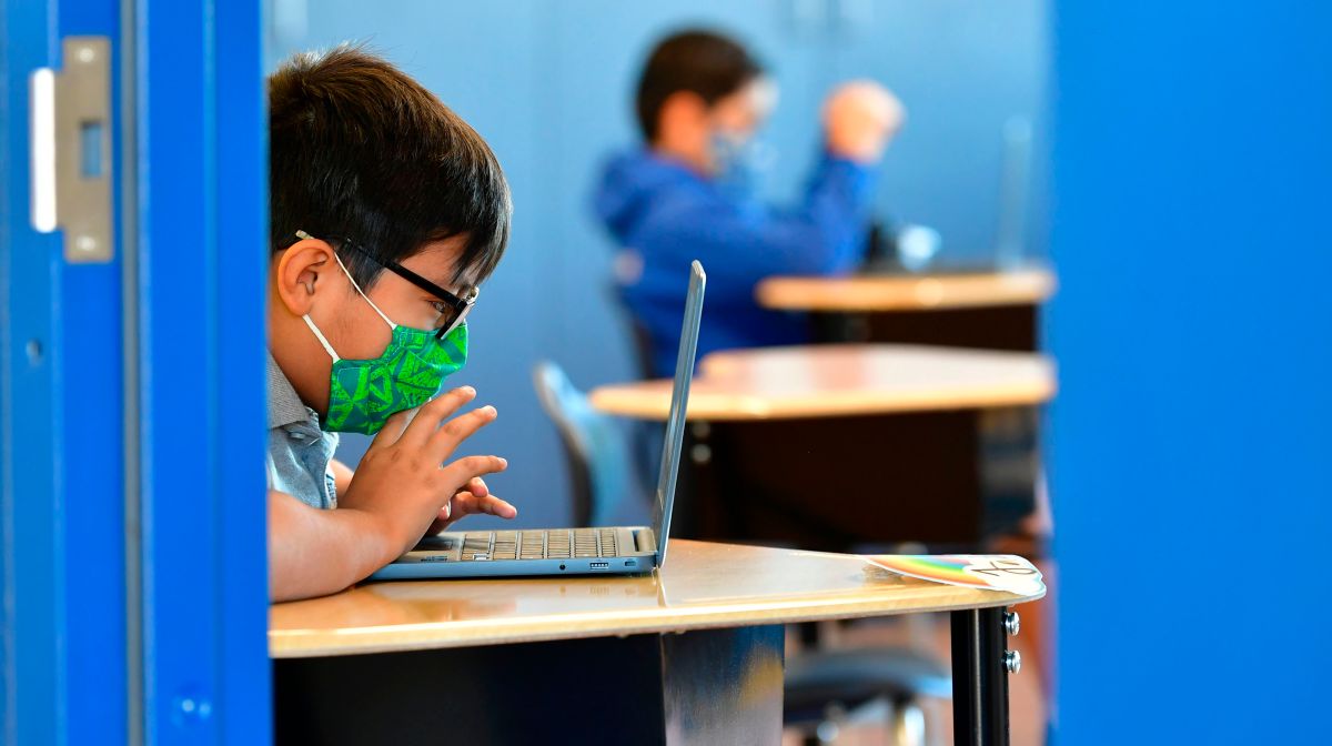 student studying on laptop at school