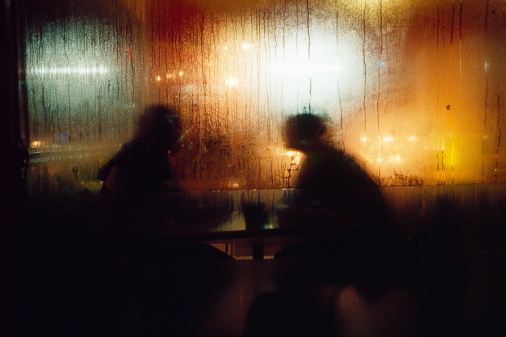 silhouettes of people at a bar