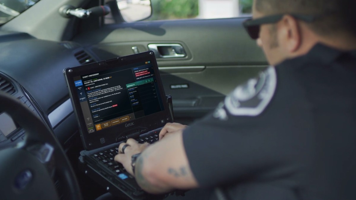 cop using patrol car computer