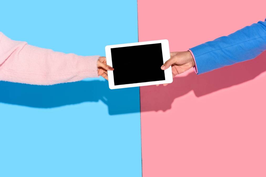 two people holding tablet