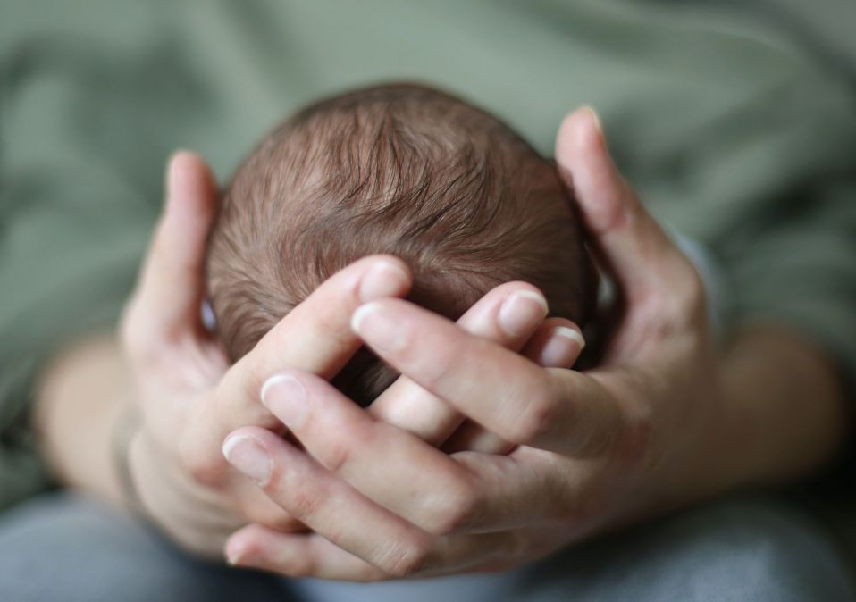 baby head in hands