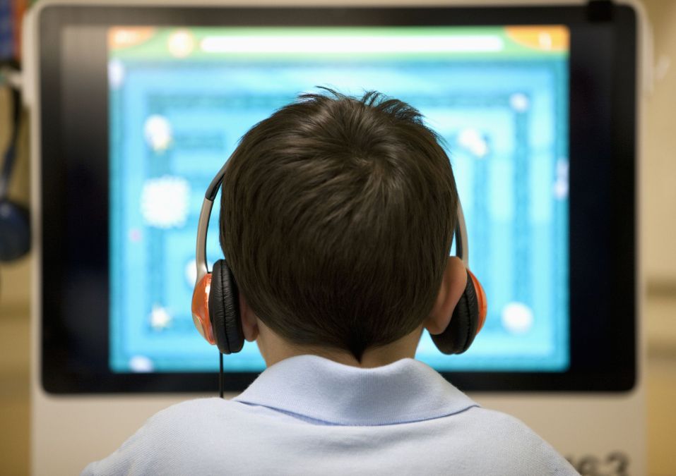 back of kid's head at computer