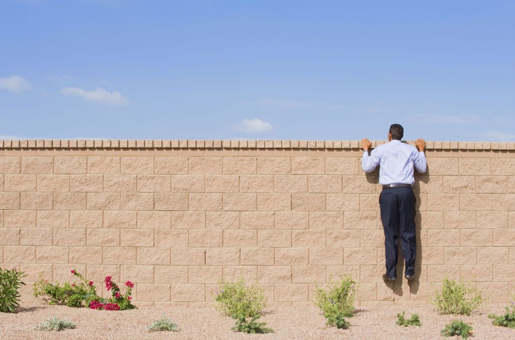 man looking over wall