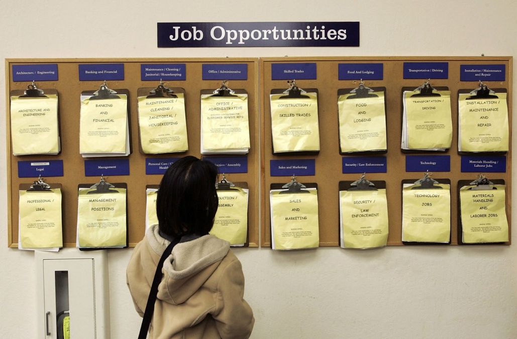 woman looking at job board