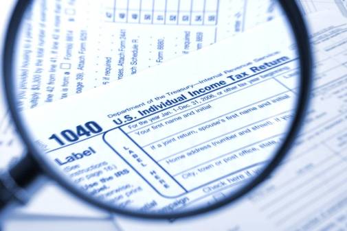 magnifying glass over tax form