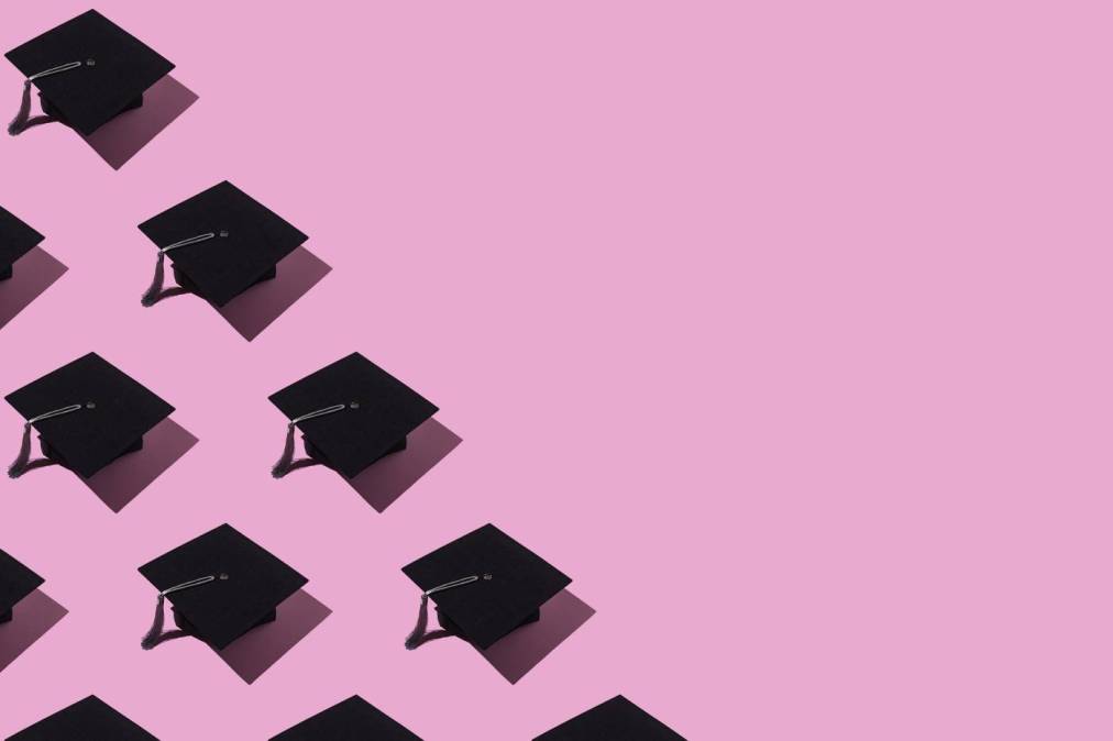 mortarboards on pink background