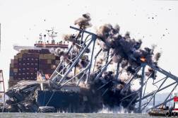 Crews conduct a controlled demolition of a section of the Francis Scott Key Bridge